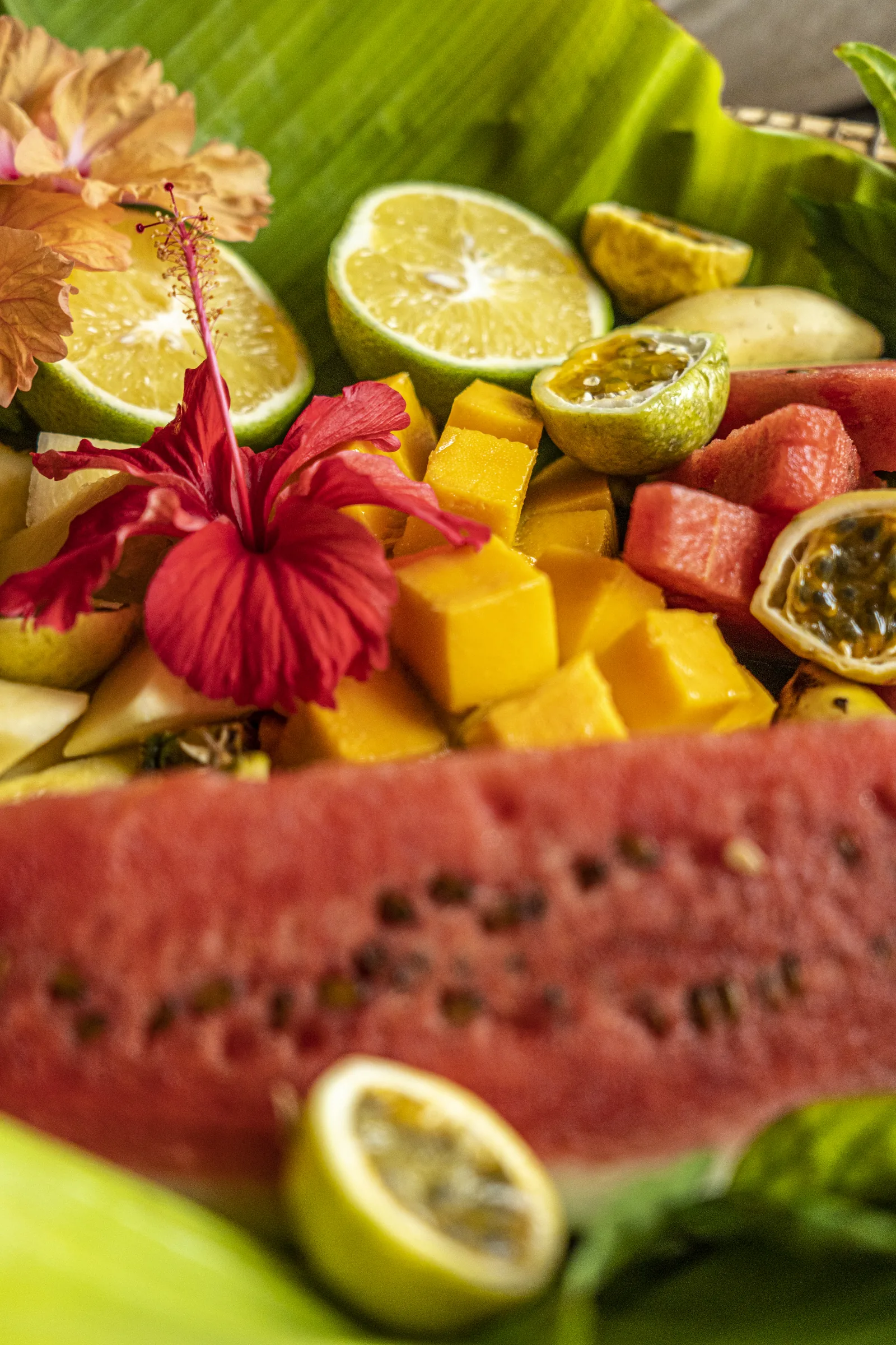 Plate of tropical Zanzibar fruit decorated with hibiscus