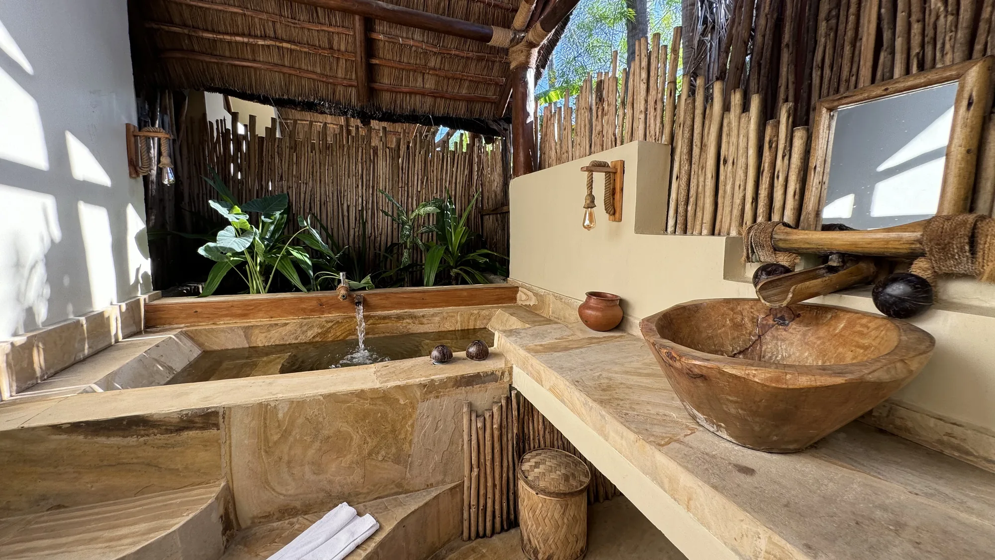 Outdoor bathroom with double basin among greenery